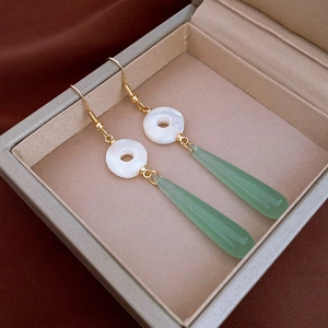 Long dangle earrings with gold hooks, white shells, and green drop stones in Neo-Chinese style