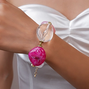 Detail of chunky acrylic irregular beads with marble pattern and gold metal spacers