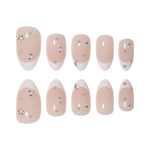 Short oval French press-on nails in nude pink with silver star and moon charms