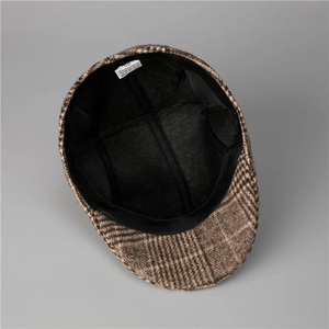 Detail view of the interior lining, size 58 label, and stitching of the brown plaid cap