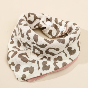 Detail showing soft four-layer cotton gauze baby bib with leopard print and snap closure