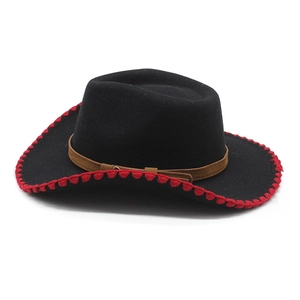 Detail of black felt cowboy hat with red stitched brim and brown leather band decoration