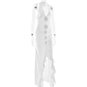 Detail of white halter neck dress with 3D floral accent and tiered ruffle hemline