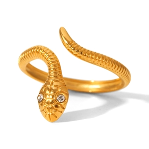 Detail of golden snake ring featuring sparkling zircon eyes and textured scales