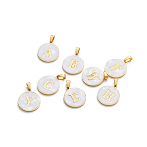 Collection of golden rimmed 22mm shell alphabet pendants with various letters on white back