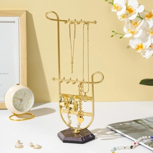 Gold metal jewelry stand with black marble base for necklaces and earrings