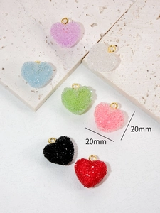 Macro detail of 20mm sugar-coated heart charms in seven colors with gold loops
