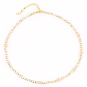 Detailed macro view of gold-plated tennis necklace with pink and white round zircon stones