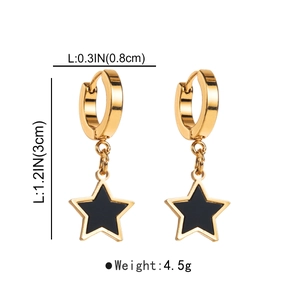 Detail view of gold star drop earrings showing 1.2 inch height and 4.5g weight metrics
