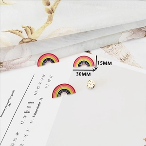 Close-up of rainbow enamel brooches featuring gradient colors and 30mm x 15mm dimensions