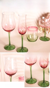 Detail of hand-painted gold rim on red gradient vintage ribbed glass wine goblet