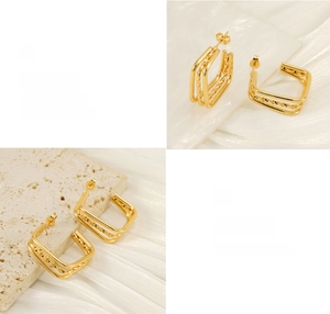 Detailed macro of gold plated geometric square earrings with multi-layered rope texture