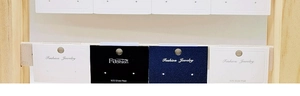Detail showing white and navy jewelry display cards for earrings and 925 silver posts