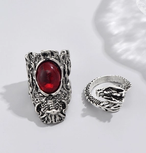 Close-up of vintage silver dragon ring and wide band set with a red oval gemstone
