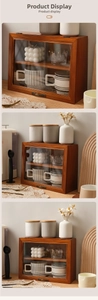 Close-up of vintage solid wood storage cabinet with glass doors and antique handles