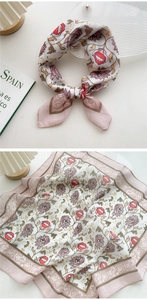 Macro detail of cotton-linen square scarf with floral, eye, and red lip prints