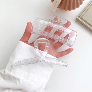 Minimalist clear acrylic hair claw clips in square and cross shapes with gold springs