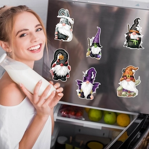 Halloween gnome skeleton magnets displayed on a stainless steel refrigerator door