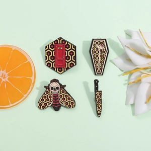 Gothic punk enamel pin set with dark patterns including dagger and skull moth