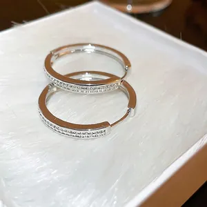 Minimalist silver hoop earrings with sparkling zircon inlay and a luxury metallic finish