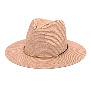 Detail of pink straw fedora hat featuring a black ribbon and gold curved metal ornament