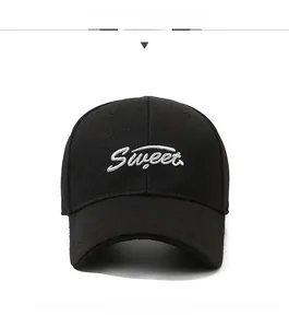 Detail view of Sweet embroidery on black cotton baseball cap with six-panel structure