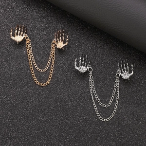 Detailed view of gothic skull hand collar chain brooches in gold and silver alloy finish