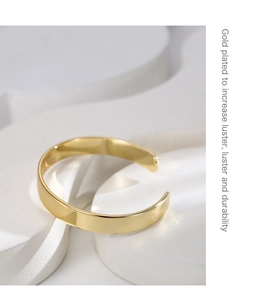 Detail of gold plated cuff bracelet showing luster and durable metal texture finish