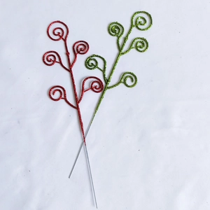 Close-up of glittery red and green spiral decorative branches for festive holiday arrangements