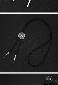 Macro detail of vintage bolo tie featuring turquoise stone and tribal silver carving