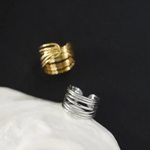 Macro shot of 18K gold and silver plated hollow multi-layer stainless steel wide rings