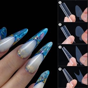 Detail of 4 clear nail extension molds and finished blue marble stiletto nails