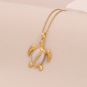 Gold stainless steel necklace featuring a sea turtle pendant with white shell inlay