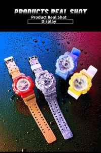 Close-up of waterproof dual-display sports watches with splashing water droplets