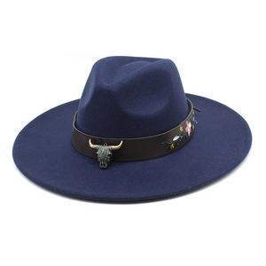 Detail of navy fedora with leather band, floral embroidery and bronze bull head skull charm