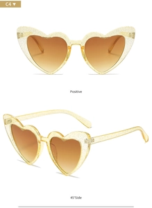 Front and 45-degree side view of yellow glitter heart-shaped sunglasses with brown lenses