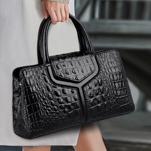 Close-up of black crocodile pattern leather texture and Y-shaped flap detail on tote bag