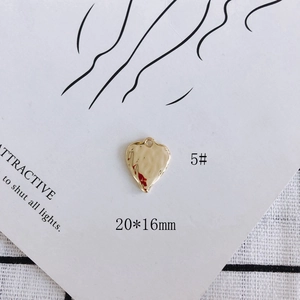 Detail of 20x16mm hammered gold heart pendant with pearl inlay for DIY jewelry making