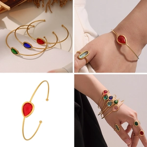 Close-up of 18k gold plated open bracelet set with teardrop Czech glass stones