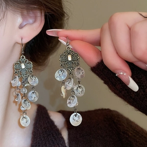 Bohemian silver drop earrings with floral engravings and pearlescent shell tassels