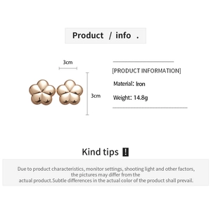 Detail view of metallic flower stud earrings with 3cm dimensions and material specs