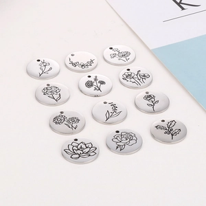 Set of 12 silver stainless steel circular necklaces with engraved floral birth month designs