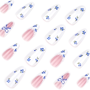 Blue and white floral press-on nails in almond shape with 3D bow and lace detail