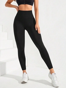 Close-up of black high-waisted yoga leggings with ribbed texture for tummy control