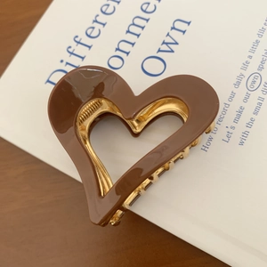 Elegant heart-shaped hair claw in glossy dark brown with golden metal frame