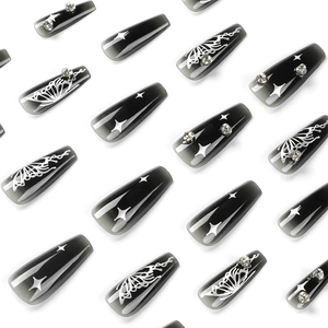 Press-on nails featuring black and silver butterfly star designs with sparkling rhinestones