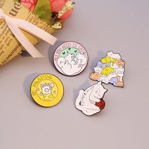 Set of four cute cartoon cat enamel pins featuring paw prints and ball of yarn designs