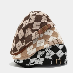 Detail showing classic argyle pattern weave and adjustable metal side buckles on flat caps