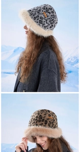 Detail of plush faux fur leopard bucket hat with fluffy trim and branded leather patch