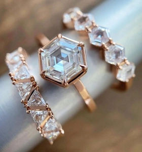 Macro detail of three-piece rose gold ring set featuring hexagonal cubic zirconia stones